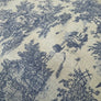 A close-up of a woven fabric with a classic toile de Jouy pattern featuring blue landscape scenes on a warm beige linen-like background.
THE DRESSMAKER FABRICS 