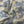 A close-up of draped fabric featuring a classic blue toile de Jouy pattern on a warm cream background.
THE DRESSMAKER FABRICS