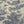 Close-up of a woven fabric with a classic toile de Jouy pattern featuring dark blue figures, animals, and foliage on a warm beige linen background.
THE DRESSMAKER FABRICS